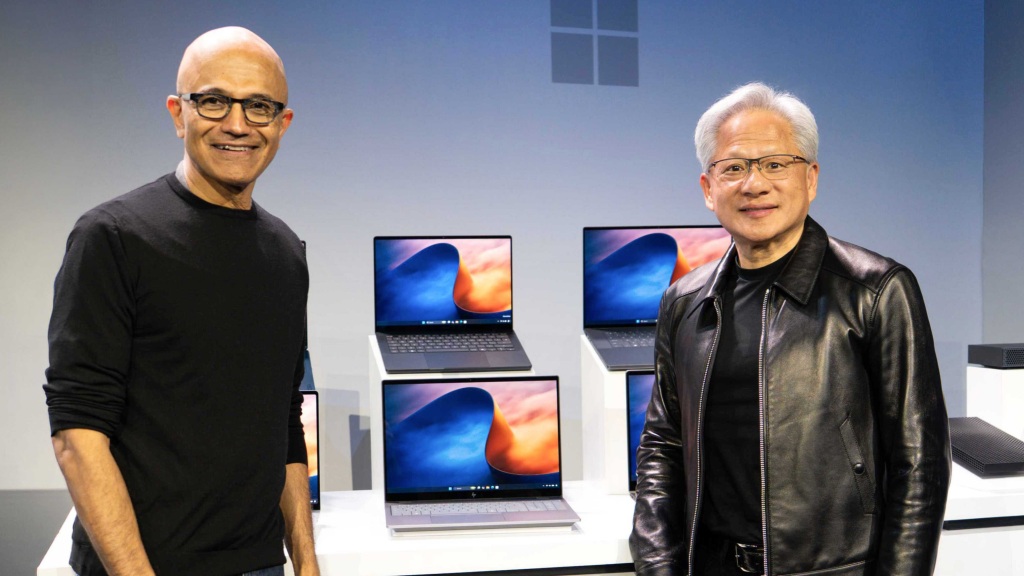 NVIDIA official event photo of Satya Nadella and Jensen Huang beside Windows laptops